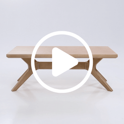 Modern wooden coffee table with unique angled legs, perfect for contemporary living room decor.
