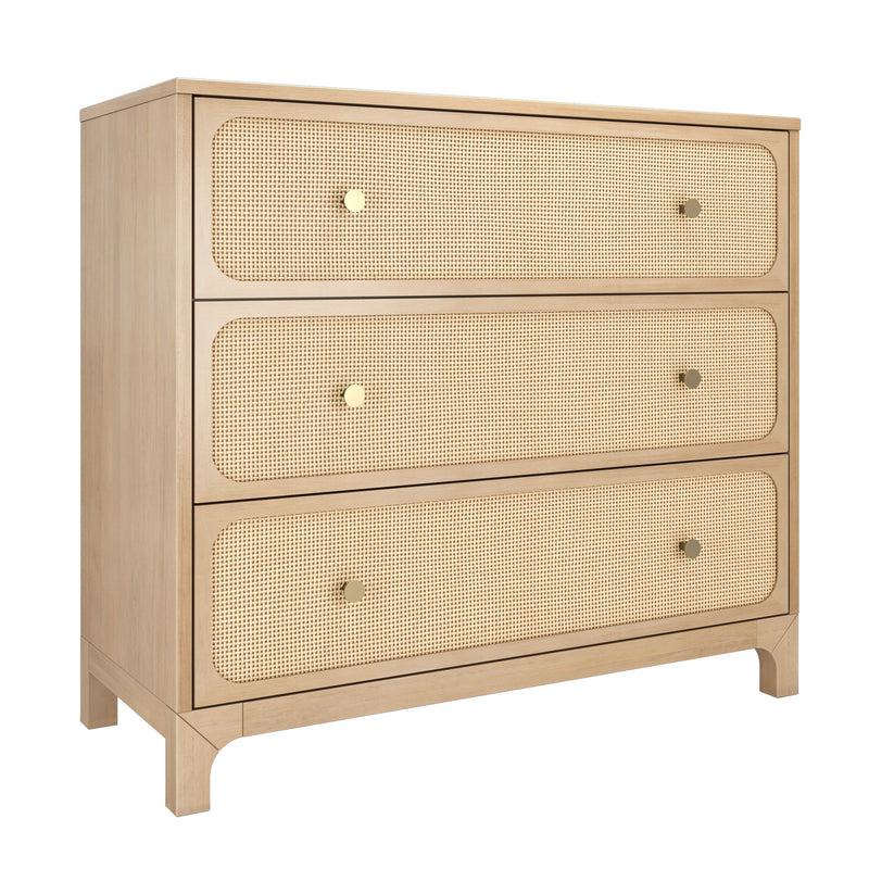 Light oak three-drawer dresser with woven cane rattan drawer fronts and brass knobs, natural wood finish coastal boho bedroom storage chest