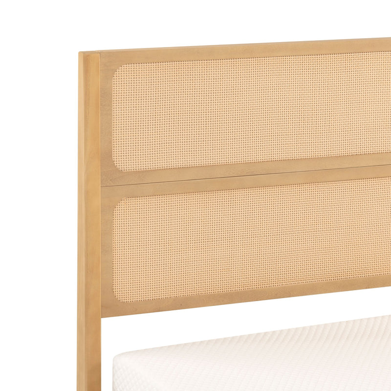 Close-up of natural wood cane headboard with woven rattan panels and light wood frame, mattress edge visible, modern boho bedroom furniture