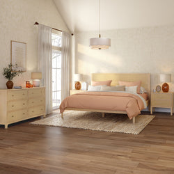 Scandinavian boho bedroom with light wood platform bed, peach bedding and pillows, woven jute rug, matching dresser and nightstands, pendant light and large window with sheer curtains — modern neutral bedroom decor