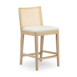 Light oak counter-height bar stool with cane rattan back, off-white upholstered seat and brass footrest — modern farmhouse kitchen island seating