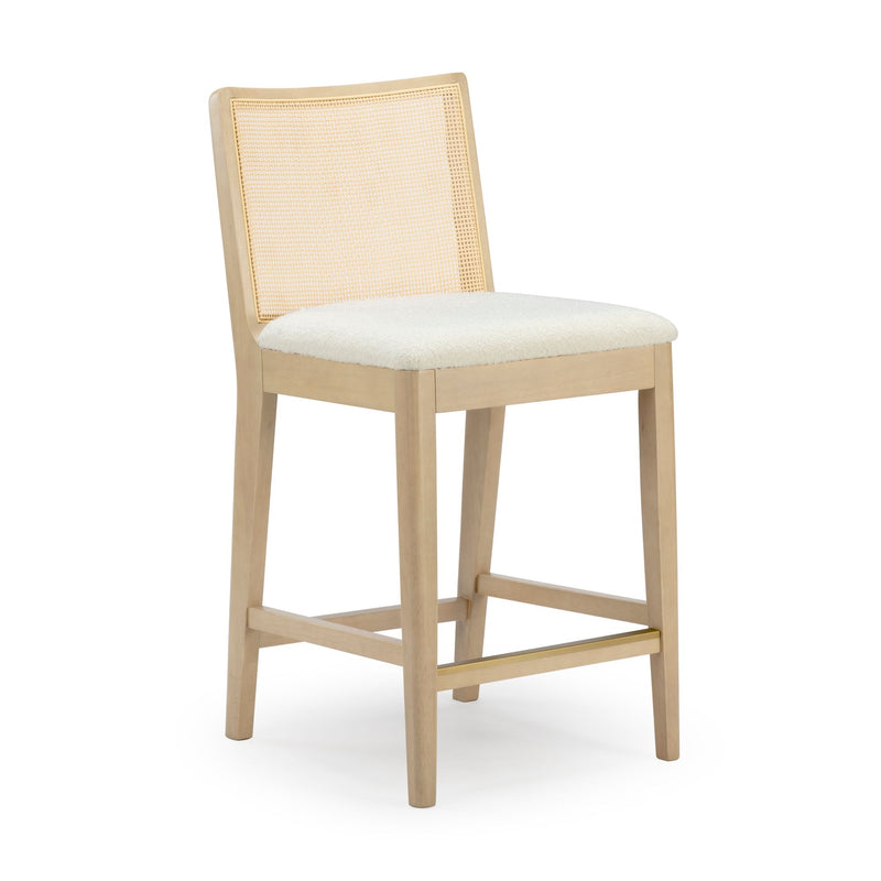 Light oak counter-height bar stool with cane rattan back, off-white upholstered seat and brass footrest — modern farmhouse kitchen island seating