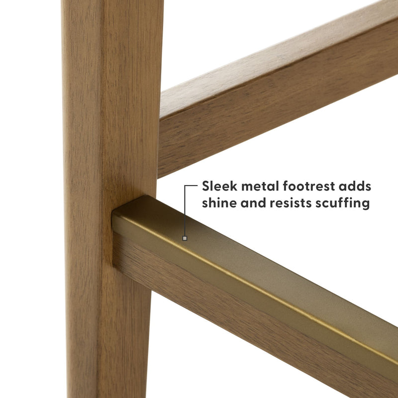 Close-up of walnut wood bar stool leg with brass metal footrest, sleek scuff-resistant footrail for modern kitchen island seating