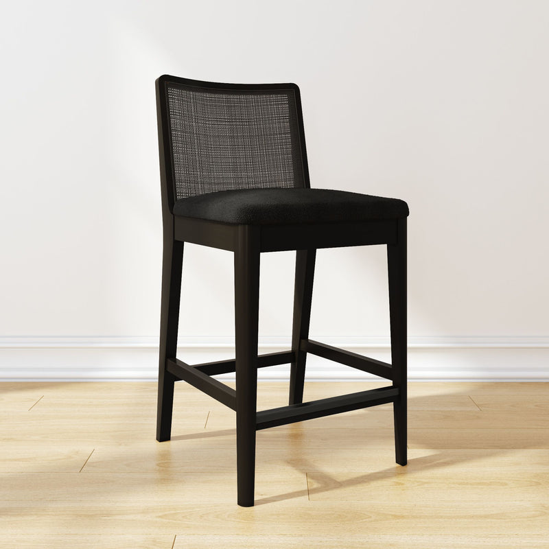 Black modern bar stool with cushioned seat and mesh backrest on wooden floor.