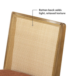Close-up of a natural woven rattan cane chair back set in a honey oak wooden frame with a rust-colored upholstered seat — mid-century modern dining chair showcasing light, relaxed textured rattan.