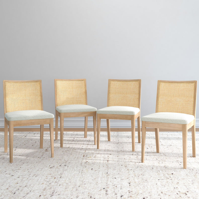 Four modern wooden dining chairs with beige cushions against a neutral background.