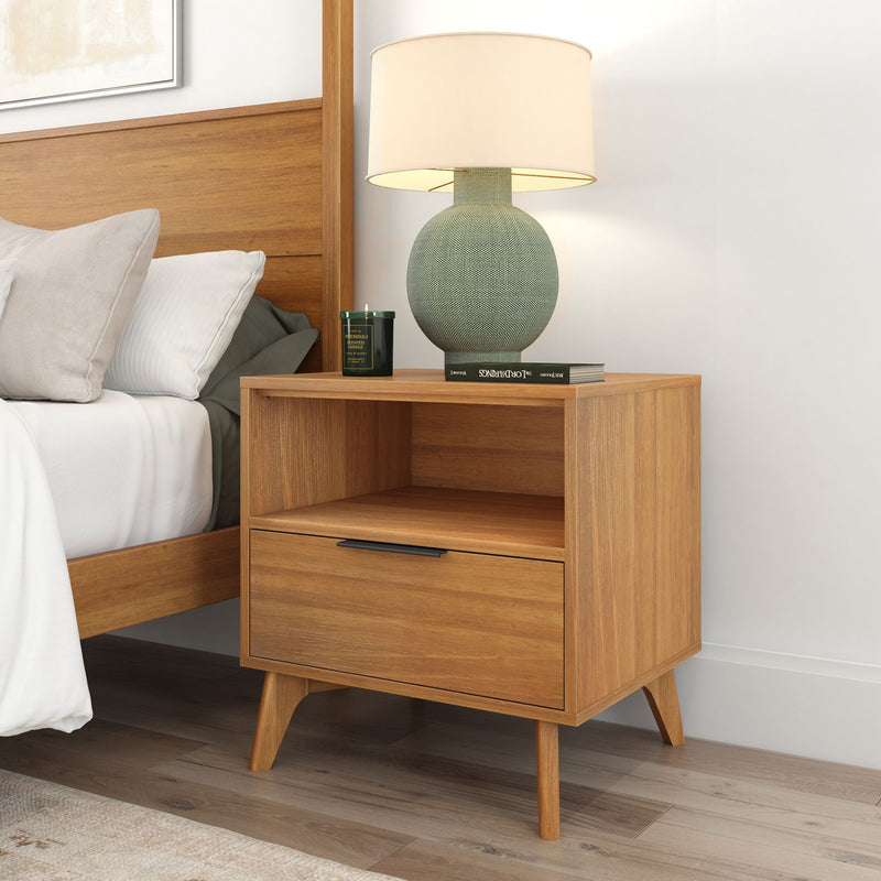 Wooden nightstand with a modern lamp and book in a cozy bedroom setting.
