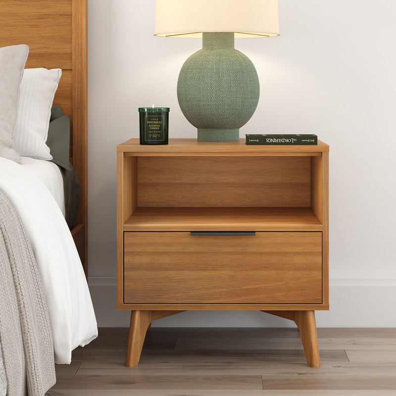 Mid-century modern wooden nightstand with drawer, green table lamp, book, and candle in a minimalist bedroom setting.