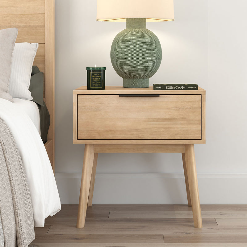 Mid-century modern wooden nightstand with a green ceramic lamp and candles, perfect for stylish bedroom decor.
