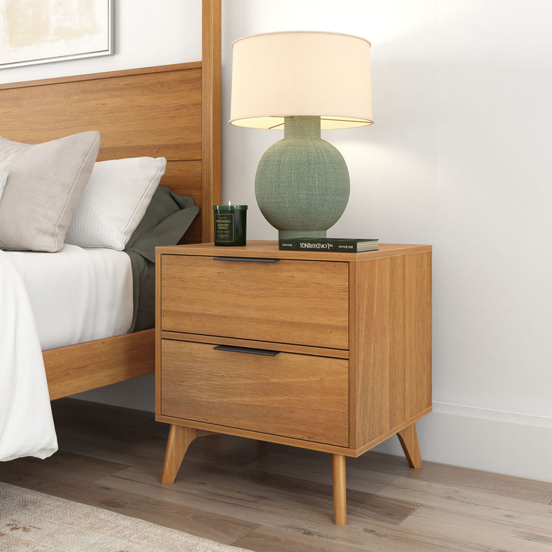 Mid-century modern wooden nightstand with two drawers, bedside lamp, and decor.