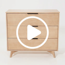 Mid-century modern wooden dresser with three drawers and minimalist design.