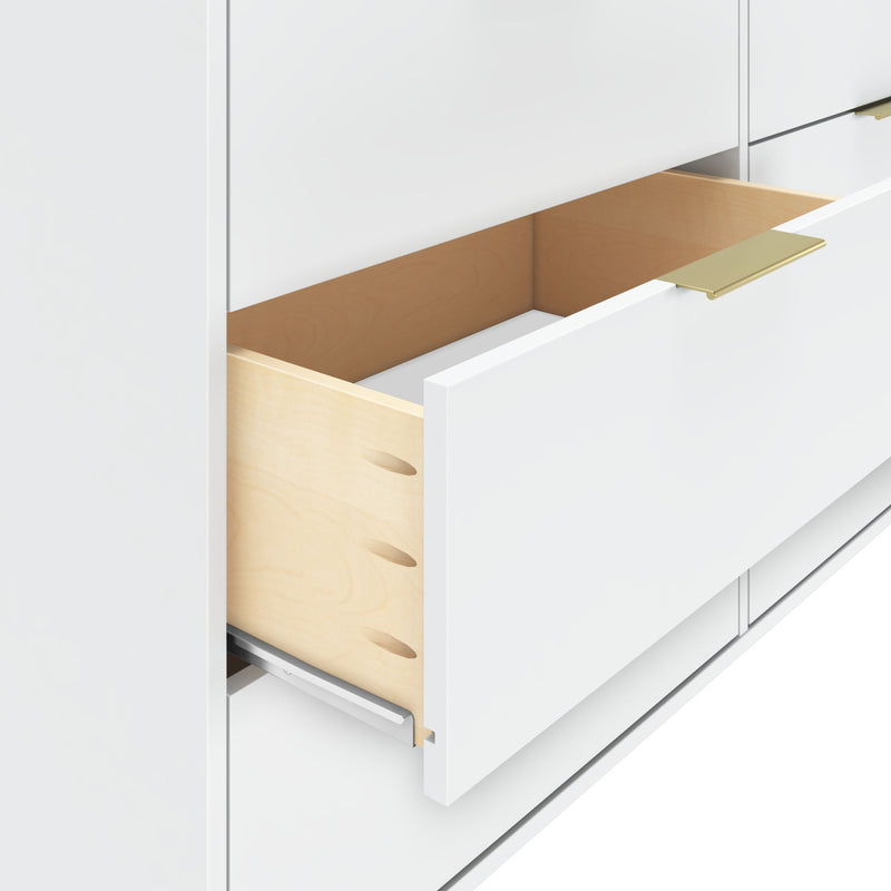 White drawer with light wooden interior and brass handle in a modern kitchen cabinet.