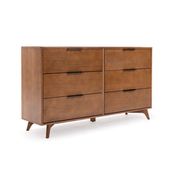 Mid-century modern 6-drawer walnut wood dresser with black handles and tapered angled legs on white background