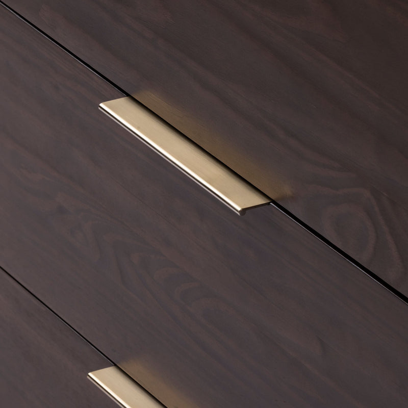 Close-up of elegant dark wood cabinet with sleek brass handle.