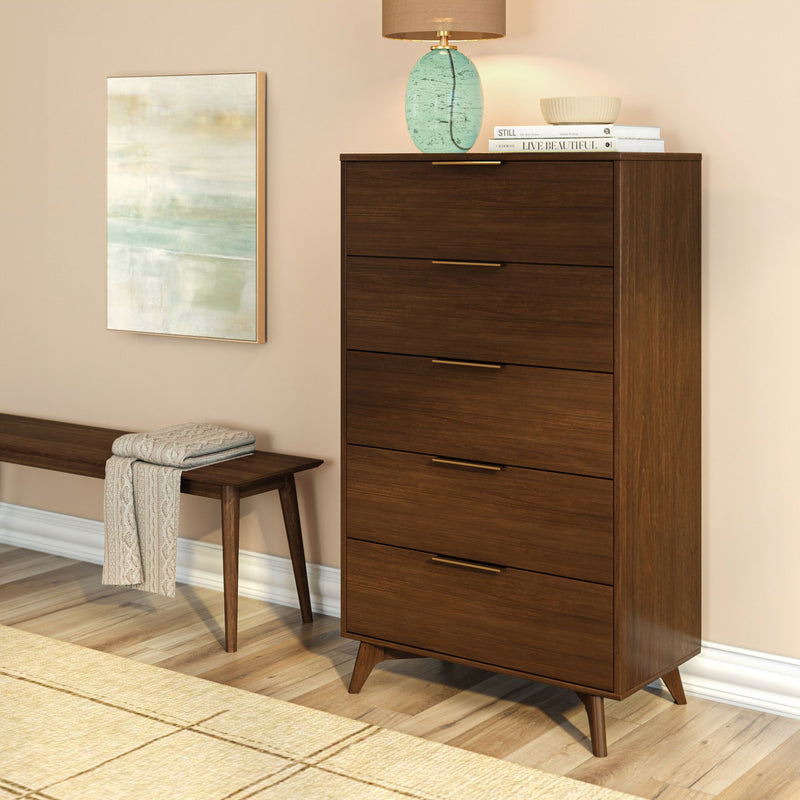 Mid-century modern walnut 5-drawer tall dresser with brass handles in bedroom/entryway, next to wooden bench, lamp and abstract wall art