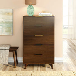 Mid-century modern walnut 5-drawer tall dresser with brass handles in styled bedroom — wooden chest of drawers for bedroom storage