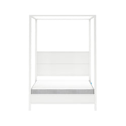 Minimalist white wooden four-poster canopy platform bed with paneled headboard and low-profile mattress isolated on white background