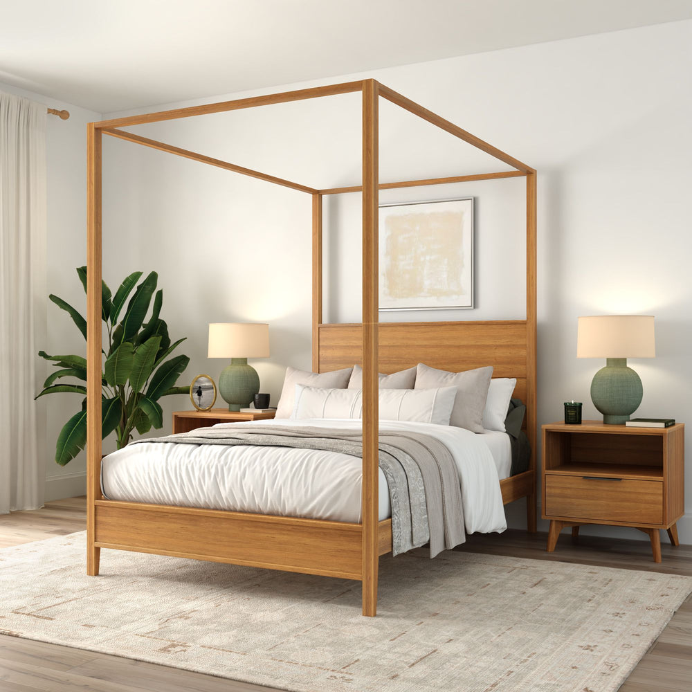 Elegant wooden canopy bed in a modern bedroom with green plants, matching nightstands, and stylish lamps.
