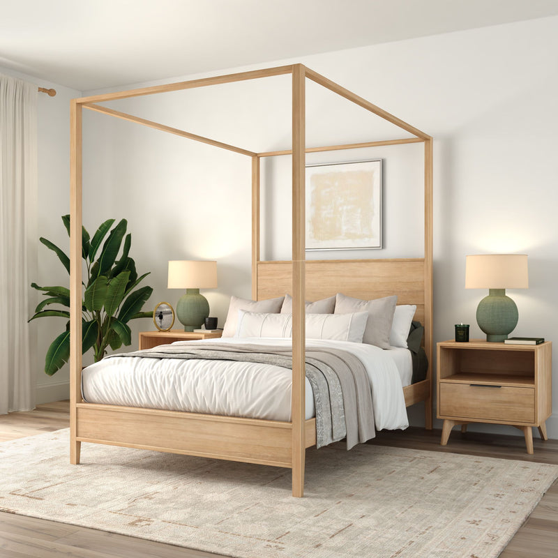 Modern light-wood canopy bed in a minimalist neutral bedroom with cozy white bedding, matching nightstands, green table lamps, abstract wall art and a potted plant