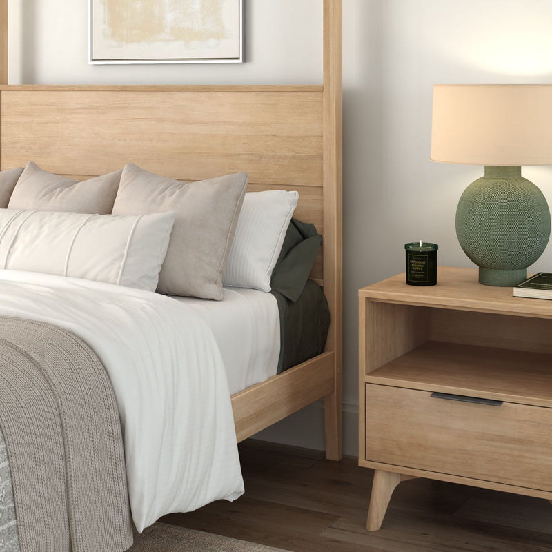 Modern Scandinavian bedroom with light wood bed frame, neutral bedding and pillows, wooden nightstand with green lamp and scented candle, minimalist home decor