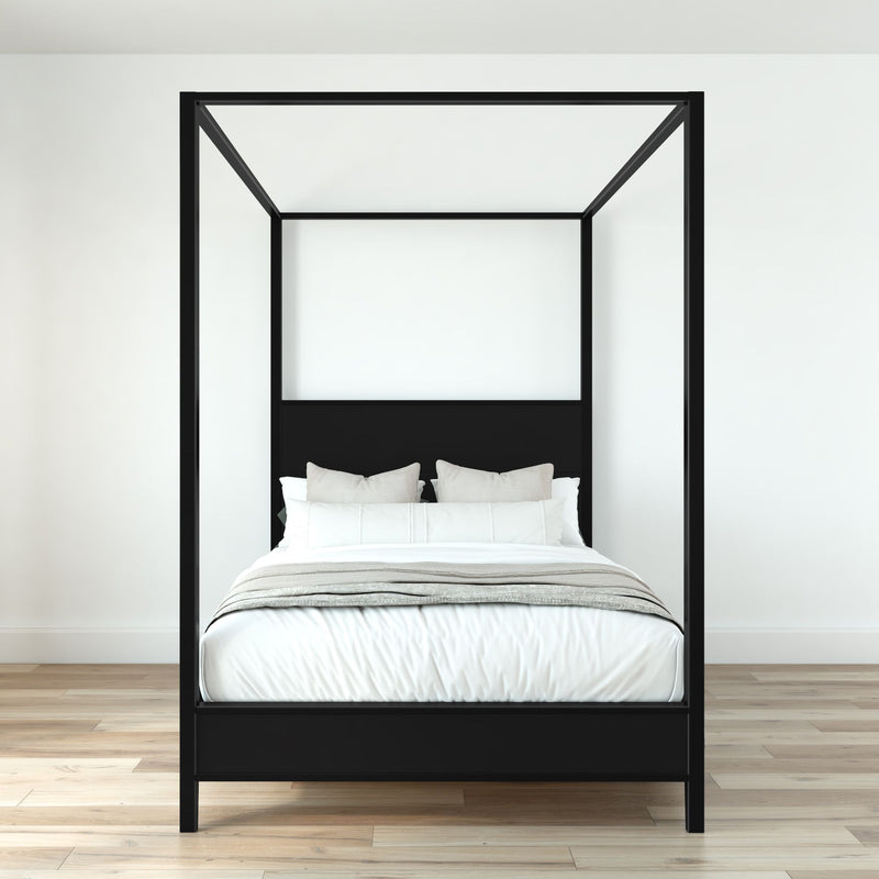 Minimalist black four-poster canopy bed with white bedding and neutral pillows on light hardwood floor in modern bedroom
