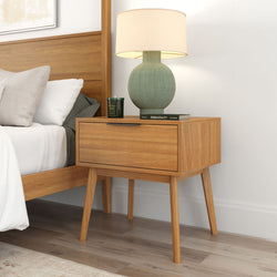 Mid-century modern wooden nightstand with lamp and books in a stylish bedroom setting.