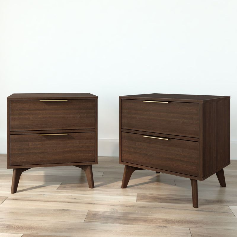 Pair of mid-century modern walnut two-drawer nightstands with brass handles and tapered wooden legs on light hardwood floor