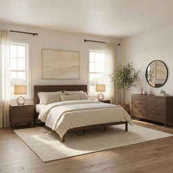 Modern neutral bedroom with mid-century wood bed and dresser, quilted bedding, bedside tables with lamps, large round mirror, textured wall art, potted olive tree, sheer curtains and hardwood floors