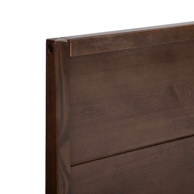 Close-up of dark walnut solid wood headboard corner showing slatted panel detail and brown wood grain finish