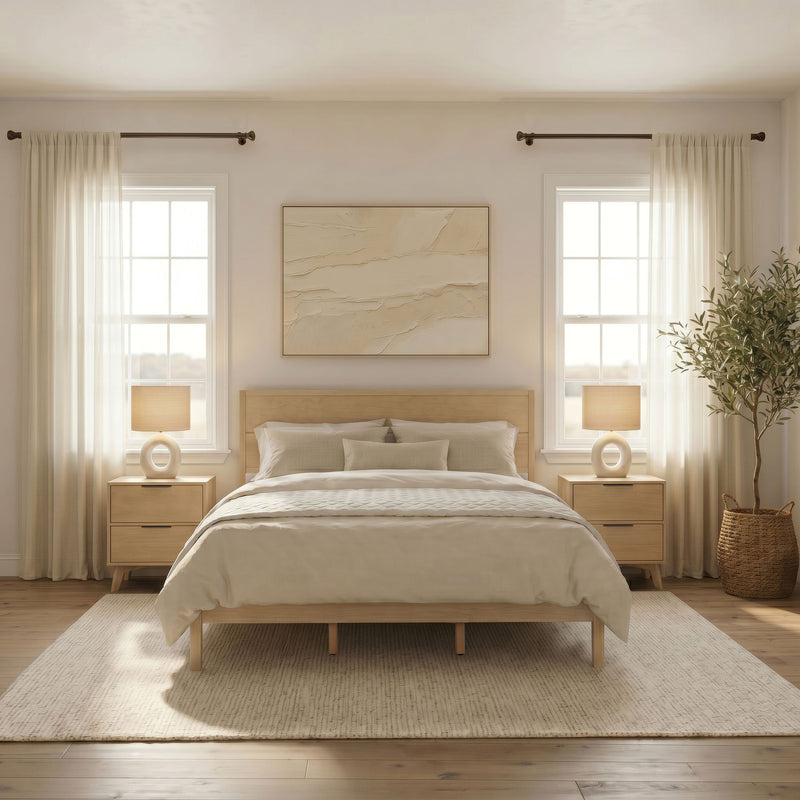 Minimalist neutral bedroom with wooden platform bed, beige bedding, matching nightstands, ceramic lamps, sheer curtains and abundant natural light