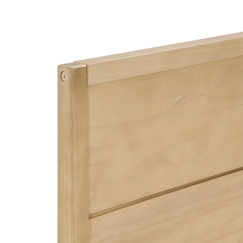 Close-up of light maple wood headboard with horizontal slats and smooth natural finish, modern bedroom furniture detail