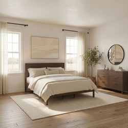 Minimalist modern bedroom with wooden platform bed, beige bedding, natural light through sheer curtains, round wall mirror, wooden dresser and potted plant