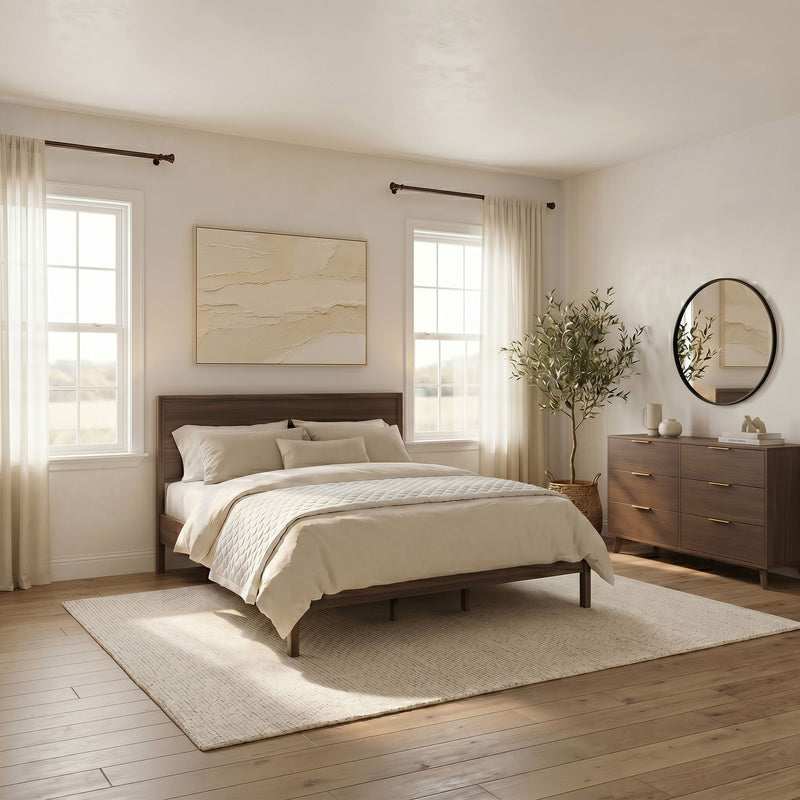 Minimalist modern bedroom with wooden platform bed, beige bedding, natural light through sheer curtains, round wall mirror, wooden dresser and potted plant