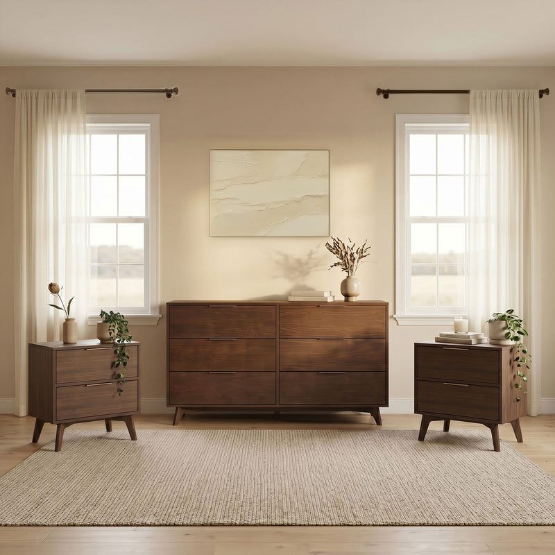 Mid-century modern bedroom with dark wood dresser and matching nightstands, sheer white curtains on twin windows, neutral wall art, decorative vases and woven area rug