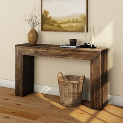 Rustic wooden console table with decorative items, wicker basket, and painting in a cozy interior setting.