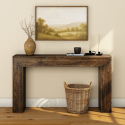 Rustic wooden console table with decorative vases, candles, and framed landscape art for stylish home decor.