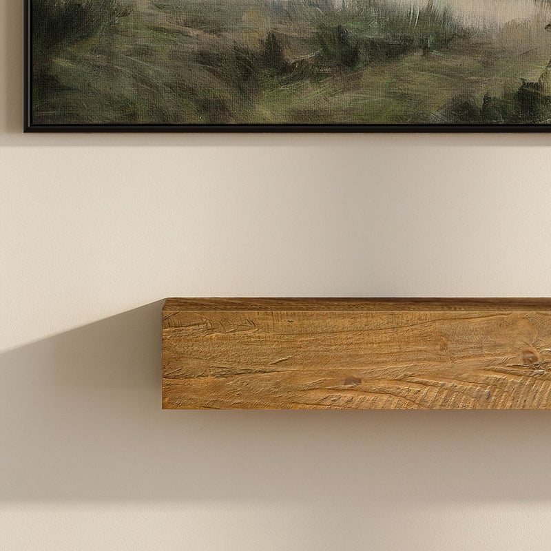 Floating rustic wooden wall shelf on beige wall beneath framed landscape painting, modern farmhouse living room decor