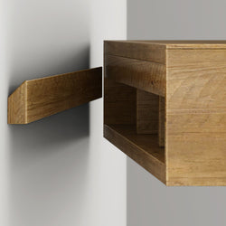 Close-up of a wooden French cleat floating shelf and wall-mounted oak shelf bracket showing the interlocking cleat mounting system for sturdy wall-mounted shelving