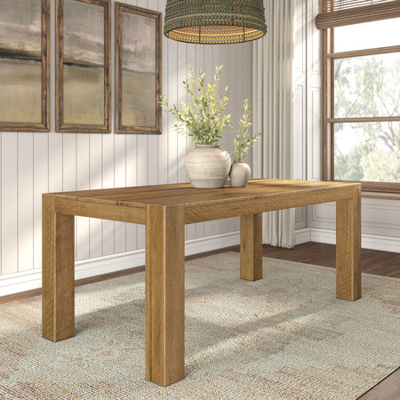 Rustic oak farmhouse dining table with ceramic vases and greenery, neutral farmhouse decor, wood-framed art and natural window light