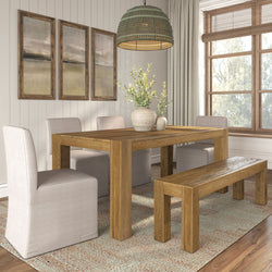 Rustic oak dining table and bench with beige upholstered chairs, beaded pendant light and ceramic vases with greenery in a neutral modern farmhouse dining room