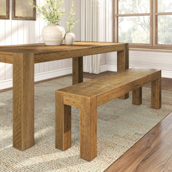 Rustic wooden dining table and bench set in a bright dining room with decorative vases and a woven rug.