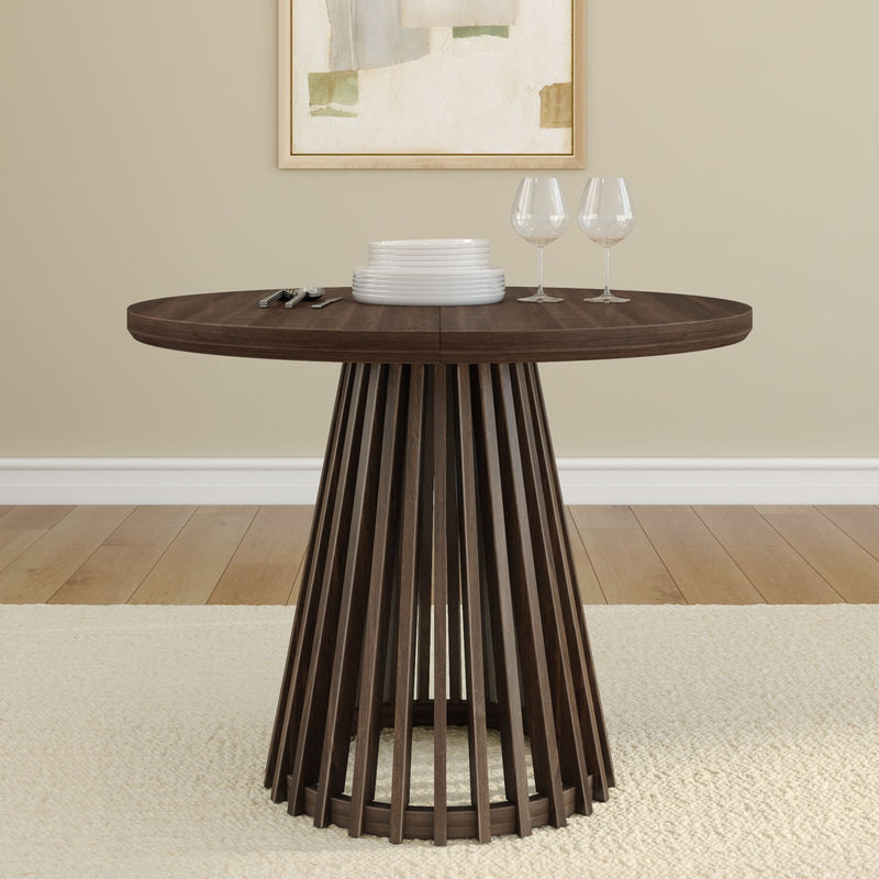 Contemporary wooden dining table with plates and wine glasses in modern home interior.