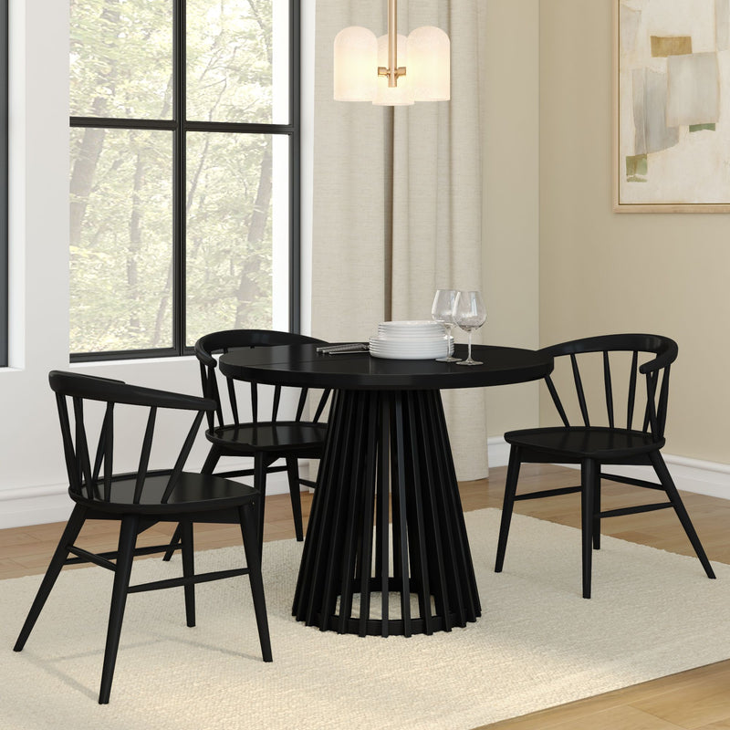 Modern black dining table with matching chairs in a stylish, minimalist dining room.