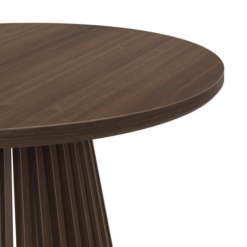 Round wooden dining table with dark finish and modern base design.