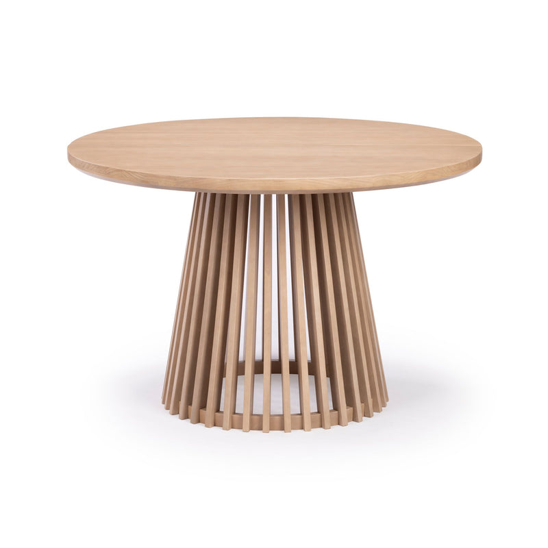 Round wooden dining table with unique vertical slat base design.