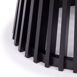 Black wooden slatted table base detail on white background, modern furniture design.