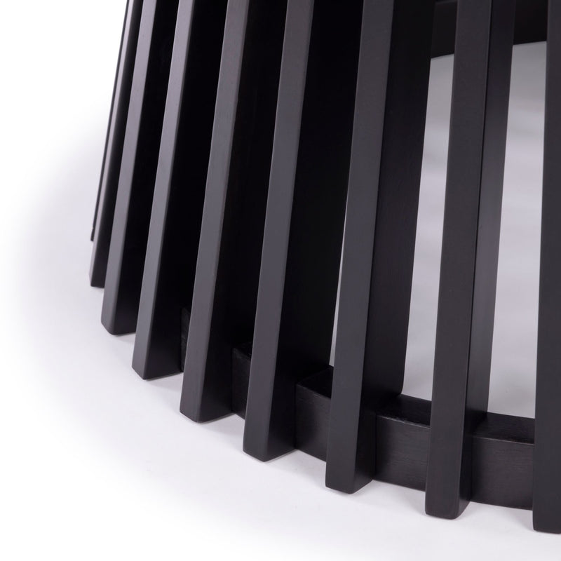 Black wooden slatted table base detail on white background, modern furniture design.