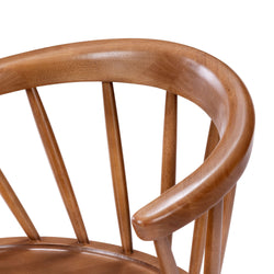 Curved wooden chair with spindle back design.