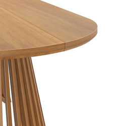 Modern round wooden dining table with unique leg design.