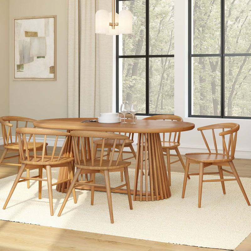 Modern dining room with a wooden table and chairs set on a light carpet, large windows providing natural light.